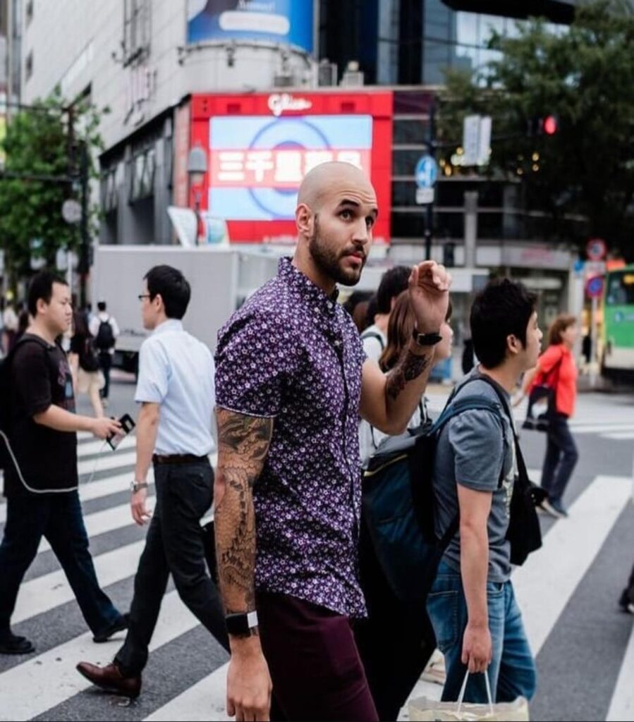 Xavier Cruz walking across a cross walk in Tokyo | Hardcore Senpai Fitness STRETCHED