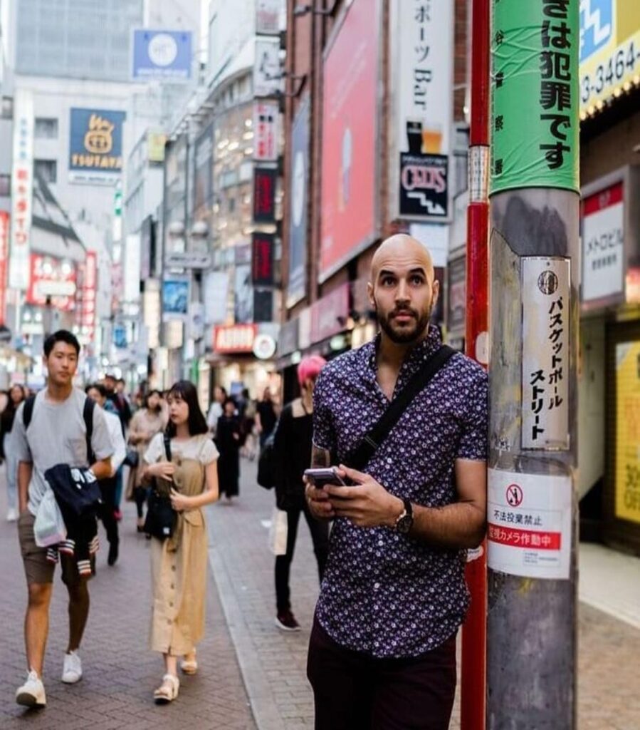 Xavier Cruz walking across a cross walk in Tokyo | Hardcore Senpai Fitness Stretched